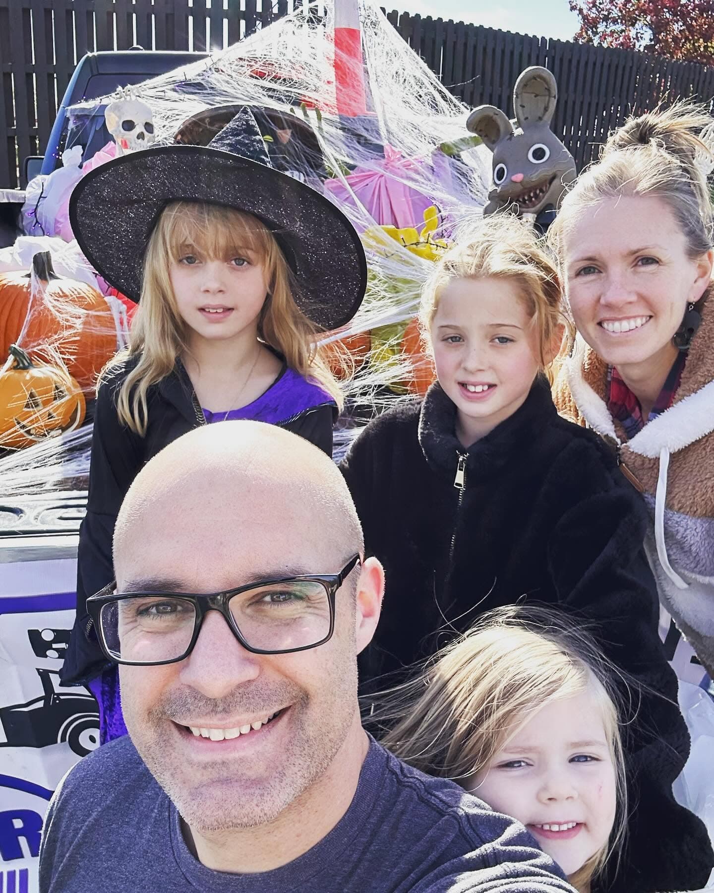 Dustin, Julie, and their three girls in front of a decorated Grateful truck.