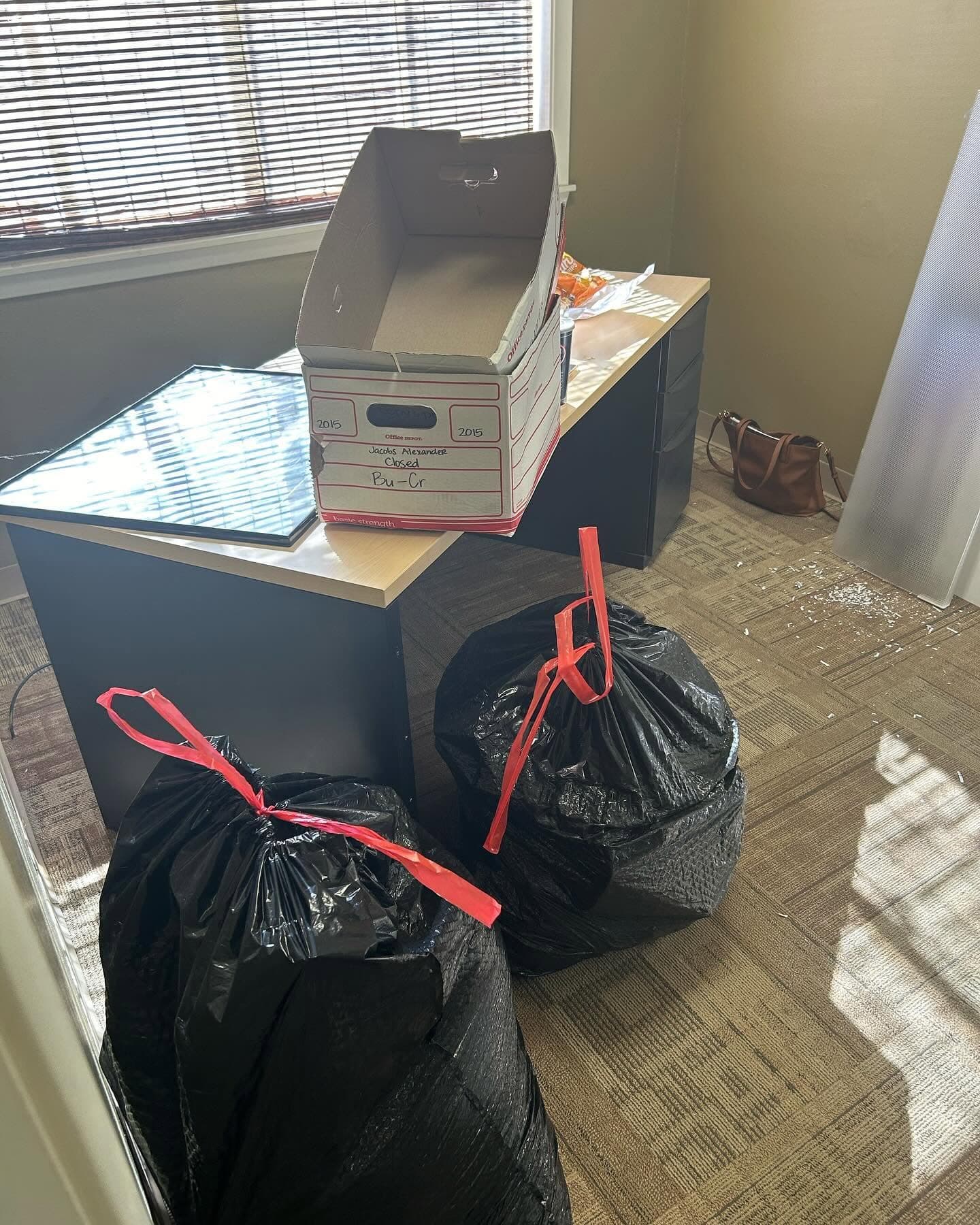 Office furniture and commercial cleanout items staged for removal.