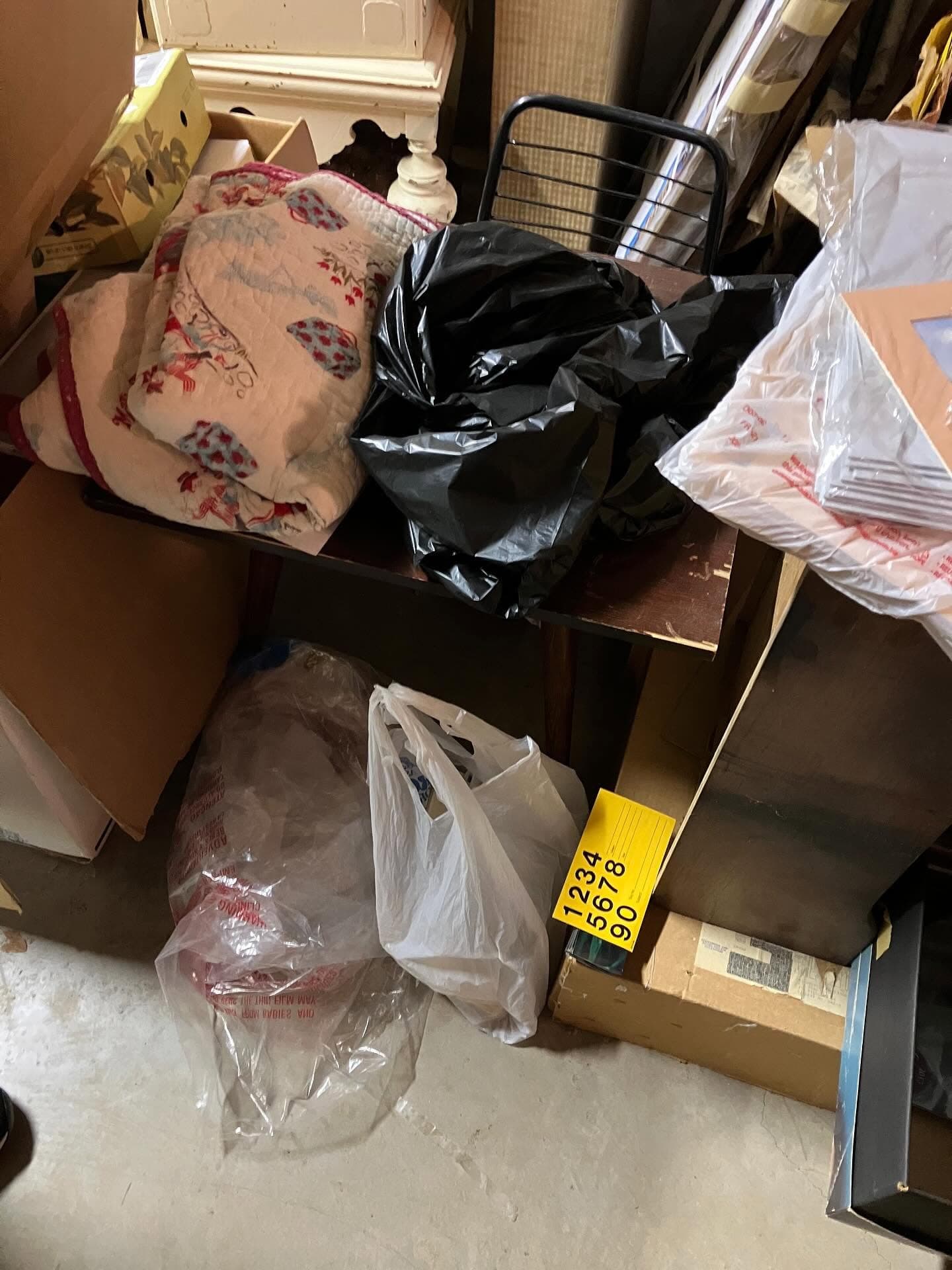 Bagged items and belongings in a heavy clutter cleanout.