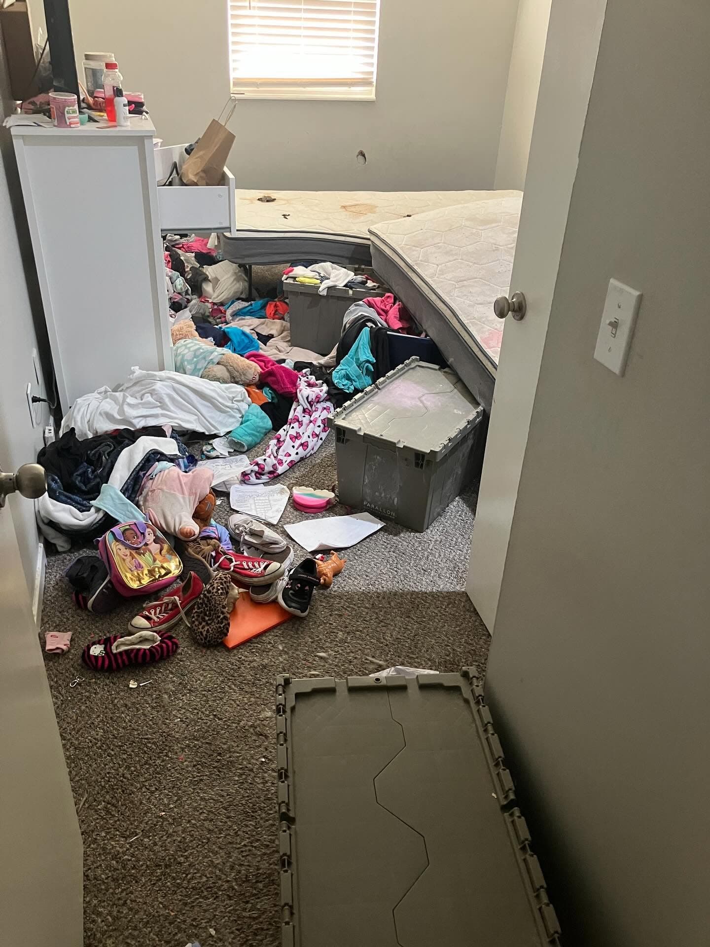 Bedroom floor before a heavy clutter cleanout.